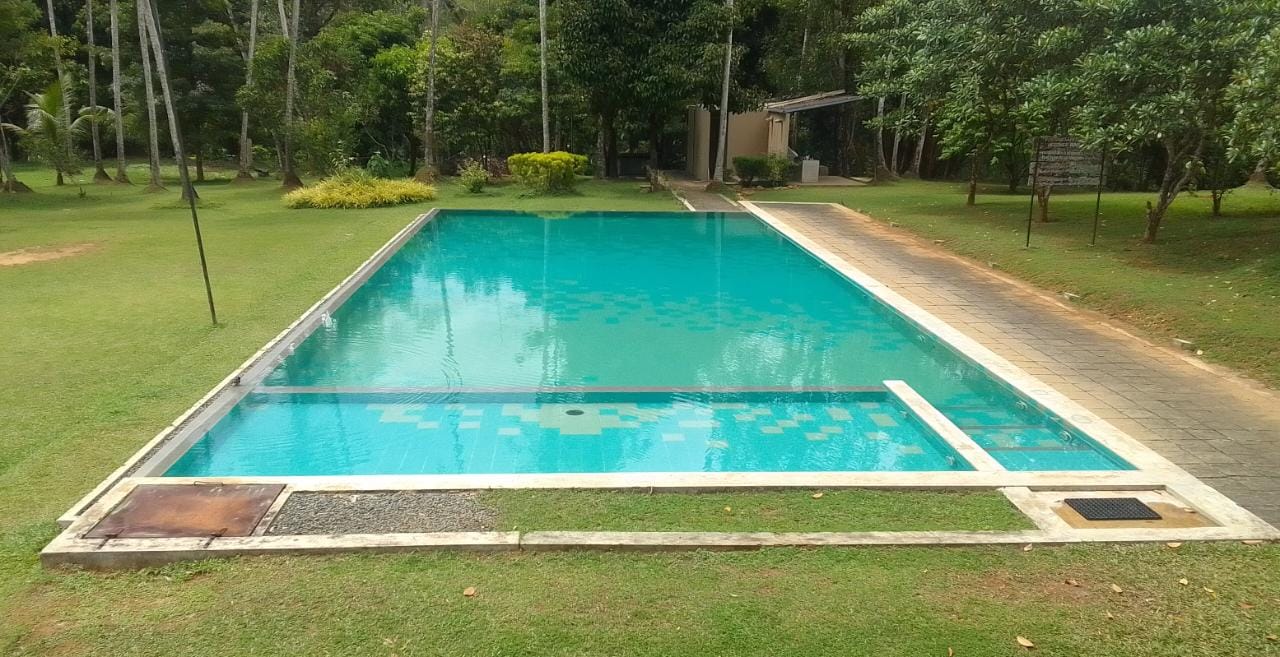 Rivonve Leisure Resort grounds and riverbank in Panawala