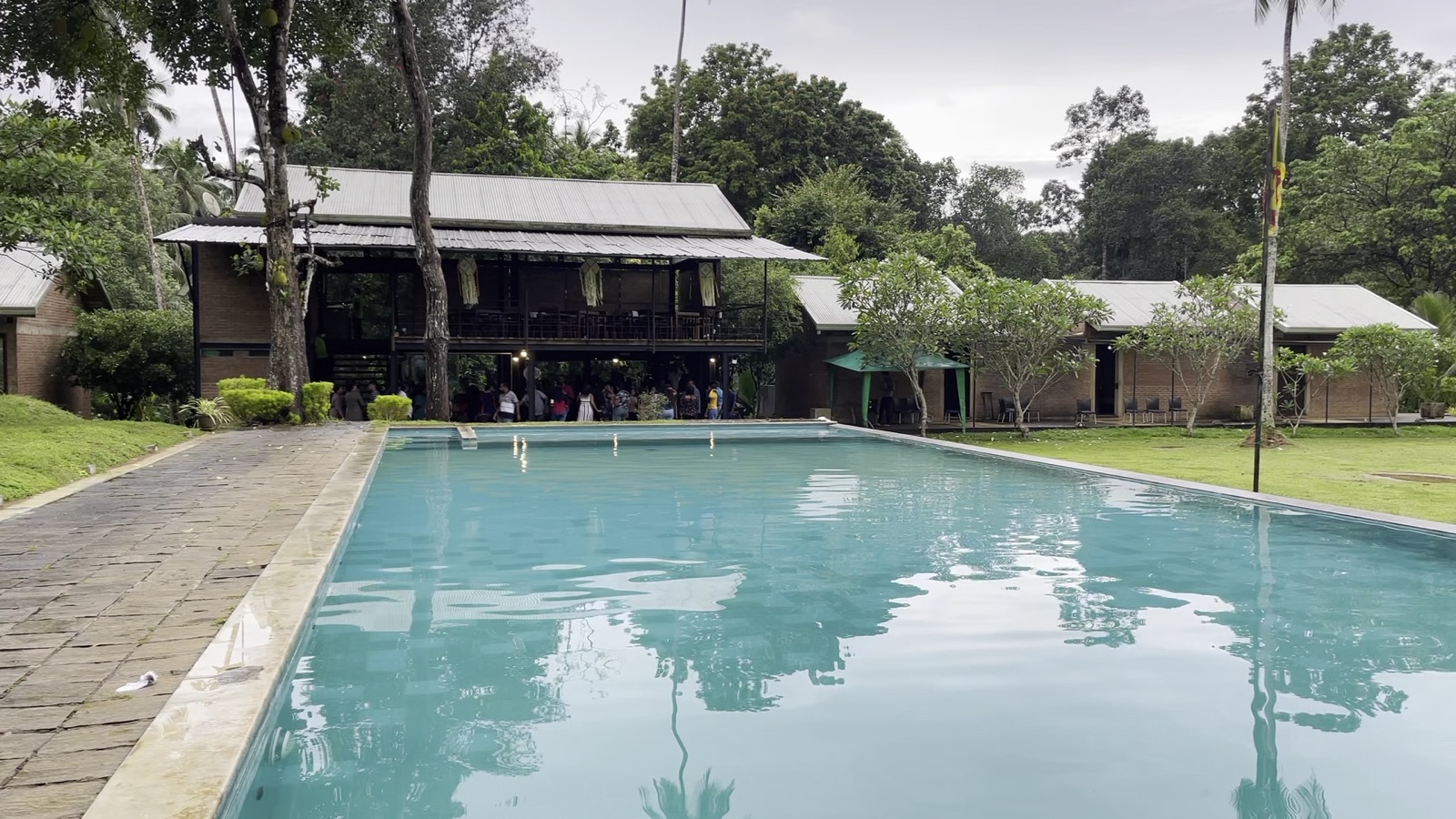 Outdoor lawn and pool area at Rivonve Leisure Resort